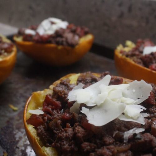 spaghetti squash boats with cheese on baking pan