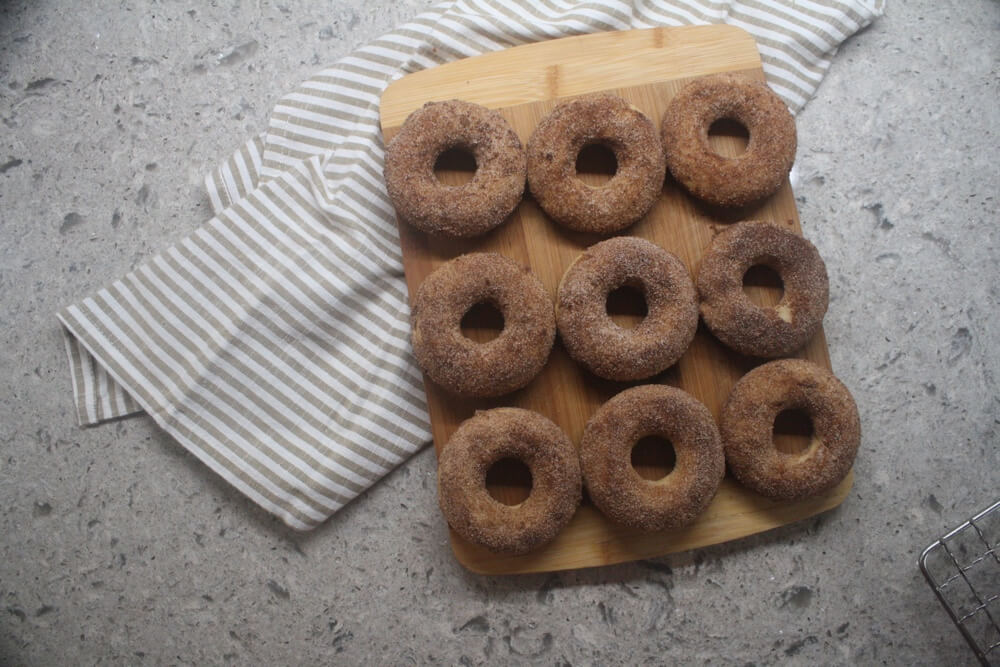 aerial view of three rows of apple cider doughnuts