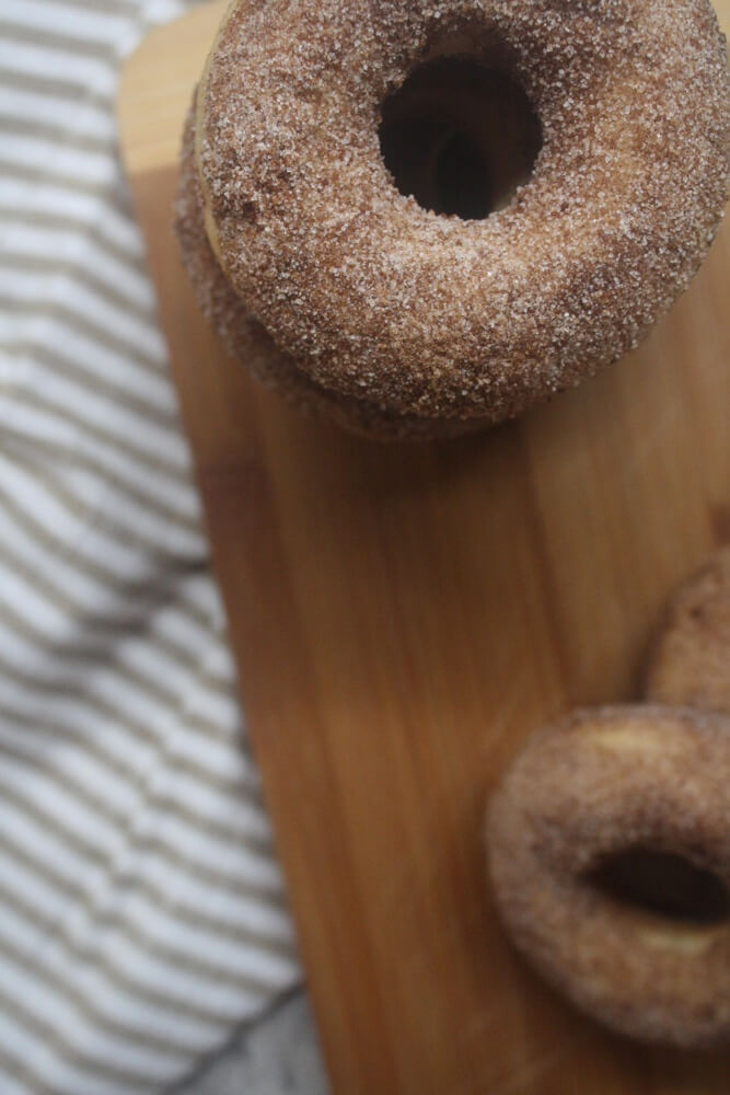 closeup aerial view of apple cider doughnut stack with striped towel in background